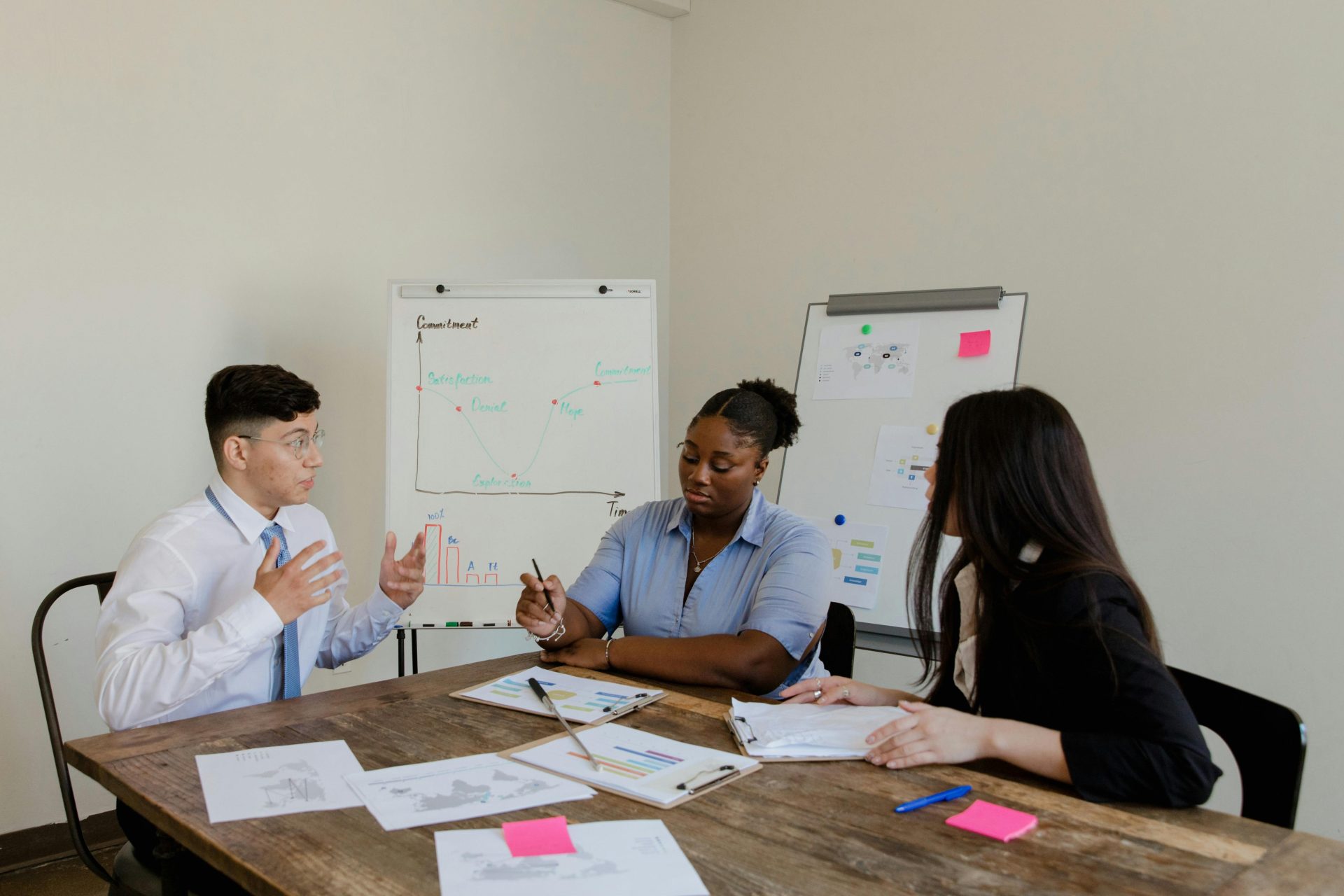 Diverse colleagues discussing plans during a corporate meeting indoors.